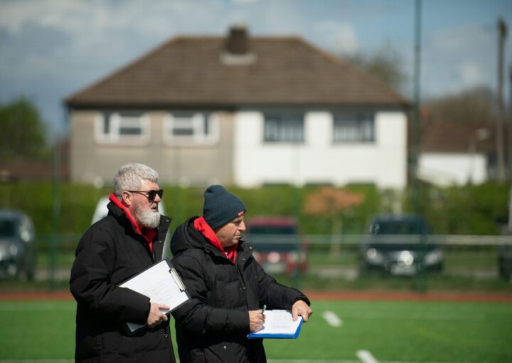 Football professionals meeting on a pitch