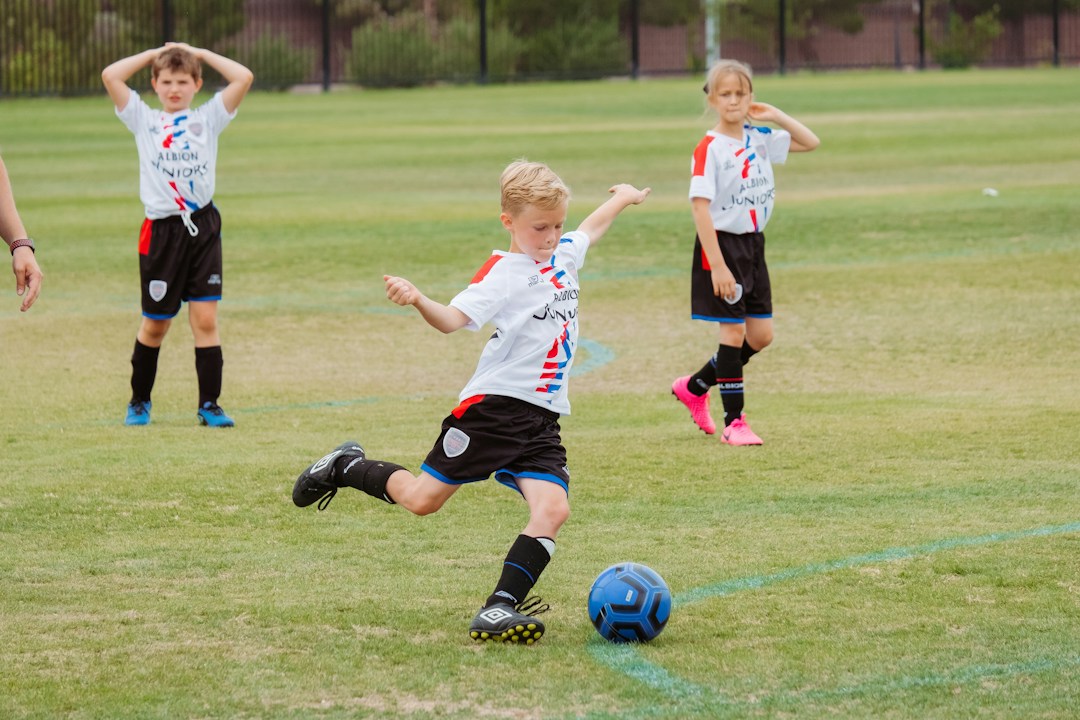 Young footballer training on a grass pitch