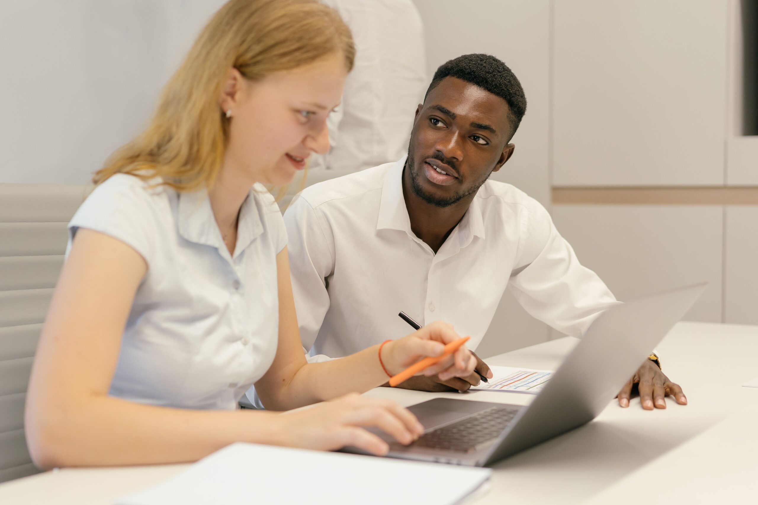 Diverse business professionals discussing a project in an office, representing sports advisory and consultancy